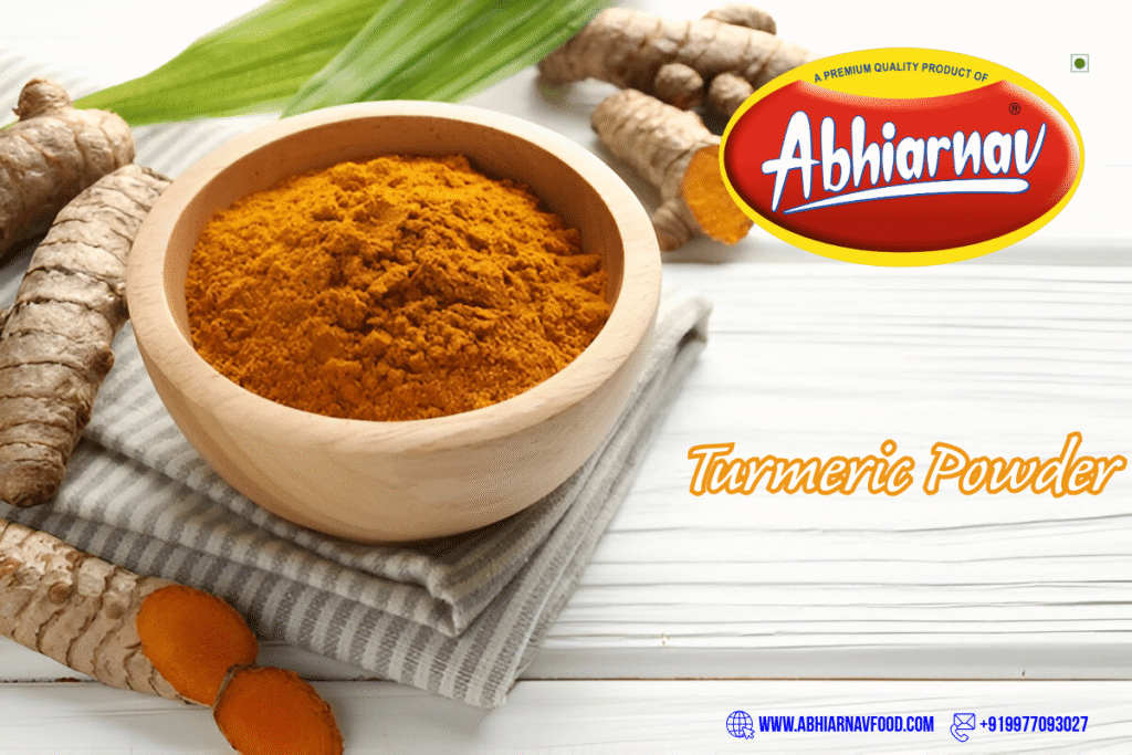 Abhiarnav Food Products premium turmeric powder in wooden bowl with fresh turmeric roots on white background.