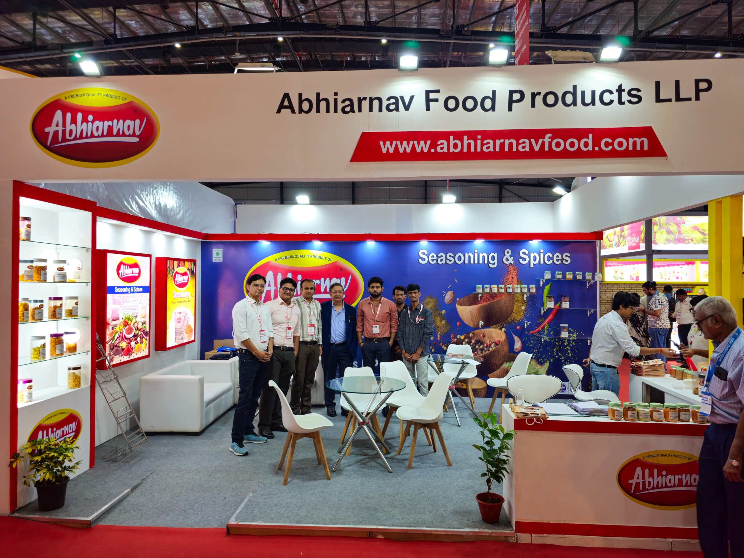 Business meeting in progress at Abhiarnav Food Products LLP booth during Anuga Food India with visitors discussing seasoning products